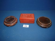A Chinese red Cinnabar lacquer box 4" wide x 2 3/4" deep x 1 1/2" high and two hardwood stands.