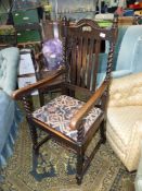 An Oak framed open armed Elbow Chair having twist legs,