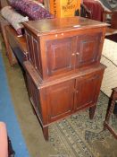 An unusual Cupboard on Cupboard having two pairs of opposed raised and fielded panelled doors,