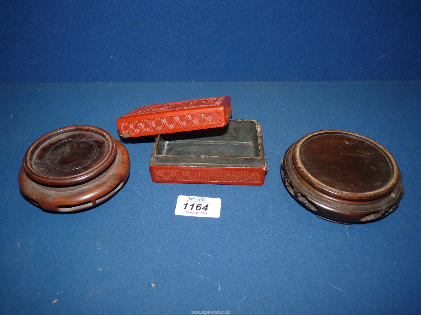 A Chinese red Cinnabar lacquer box 4" wide x 2 3/4" deep x 1 1/2" high and two hardwood stands. - Image 3 of 3