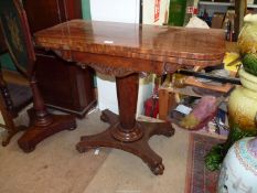 A 19th century Regency design Mahogany flap-over card table standing on a tapering octagonal pillar