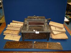 An 'Orchestral Organette' music machine, hand wound, with a good quantity of music rolls,