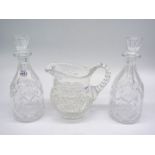 A pair of glass decanters and a cut glass water jug.