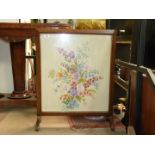 A square wood framed fire screen having embroidered flower sprays scene on cream ground,