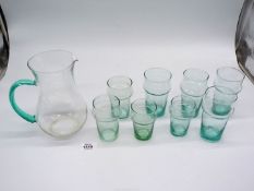 A glass lemonade set in green including a jug and eight various sized glasses.