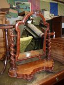An ornate Mahogany dressing table swing-Mirror having a shaped base and mirrored twist supports.