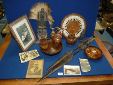 A quantity of treen including bowls, storage jar, bread board, ethnic mask and spears,