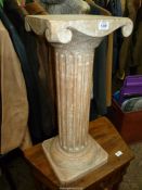 A limed wood Pedestal in the form of an Ionic pillar with fluted stem and square base,