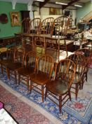 A harlequin/matched set of 12 Elm seated Dining Chairs having bent-wood backrest frames,