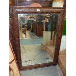 A large wall mirror having carved dark wood frame, 31" x 43".