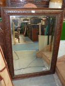 A large wall mirror having carved dark wood frame, 31" x 43".