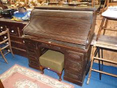 A dark Oak double pedestal roll-top Desk having a frieze drawer over the kneehole and four drawers