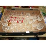 A quantity of glasses including eight red stemmed champagne flutes, hock glasses,