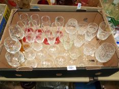 A quantity of glasses including eight red stemmed champagne flutes, hock glasses,