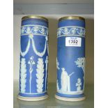 A pair of blue Wedgwood vases (both crack to rim), 8" tall.