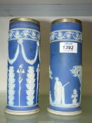 A pair of blue Wedgwood vases (both crack to rim), 8" tall.