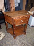An unusual peg-joyned Oak Side Table having a frieze drawer with a fluted front,