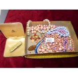 A quantity of costume jewellery including beads, brooches etc.