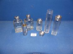 A small quantity of vanity bottles with silver tops and shaving stick, hallmarks for London, 1907.
