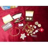 A quantity of costume jewellery including brooches, bracelets and cuff links.