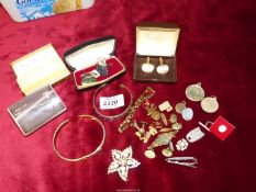 A quantity of costume jewellery including brooches, bracelets and cuff links.