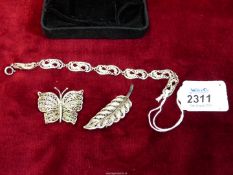 A five panel filigree bracelet stamped sterling and a silver filigree leaf brooch stamped 925 plus