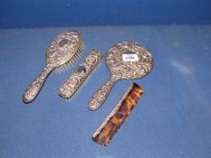 A silver backed dressing table set, Birmingham 1965, comprising hand mirror, comb, hairbrush,