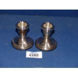 A pair of small silver candle holders,