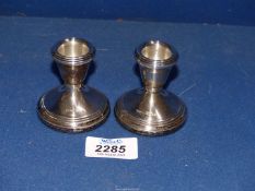 A pair of small silver candle holders,