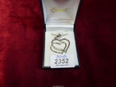 A silver necklace with double heart pendant by Event, in box.
