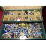 A green jewellery box and contents including clip-on earrings, necklaces, rings etc.
