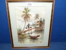 A framed and mounted Oriental Watercolour depicting a figure carrying baskets to hut on stilts,