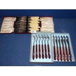 A set of six fish knives and forks and a set of six steak knives.