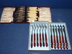 A set of six fish knives and forks and a set of six steak knives.