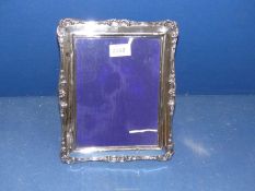 A silver photograph frame, Birmingham, 1905, possibly by Walter Jones, 10 1/2" x 8 1/2".