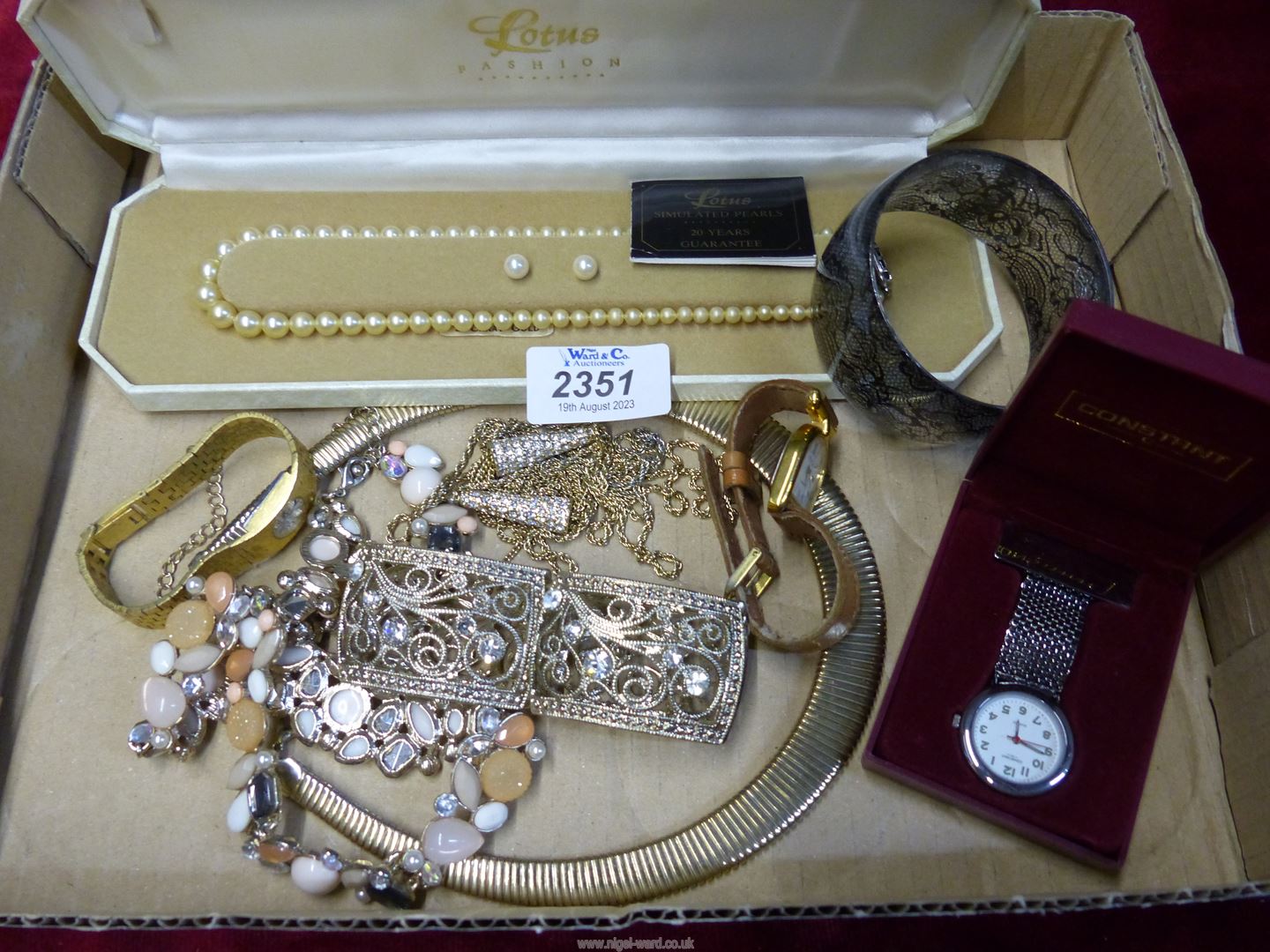 A quantity of costume jewellery including watches, faux pearl necklace and earrings,