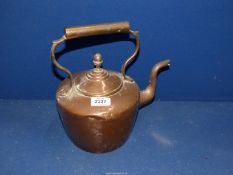 A copper kettle having acorn finial.