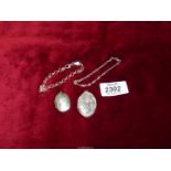 Two silver lockets and two sterling silver bracelets.