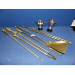 A quantity of brass Fire Irons and two plated trophies.