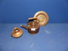 A copper kettle, copper and brass jug and Islamic style plate.