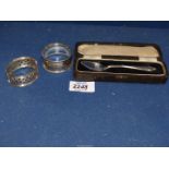 Two silver Napkin Rings and cased Teaspoon, Birmingham, various makers and dates, 36 grams.