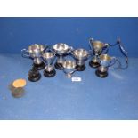 A quantity of small silver plated trophies with plinths.