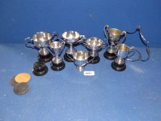 A quantity of small silver plated trophies with plinths.