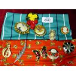 Ten brooches including butterfly, bouquet, cameos etc.