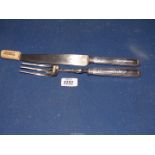 A French metal carving knife and fork set marked Paris to blade.