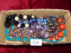 A bag of costume jewellery including necklaces and bracelets.