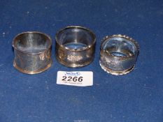 Three Birmingham hallmarked silver napkin rings, one makers C.E.