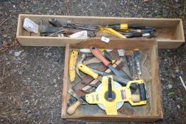 A quantity of tools and large measuring tape.