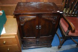 A dark oak cupboard - 26" wide x 16½" depth x 35½" high.