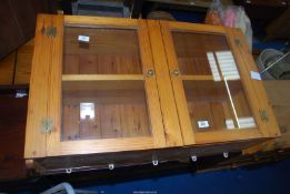 A kitchen pine cupboard with wall fittings - 35" wide x 27" high x 9½" depth.
